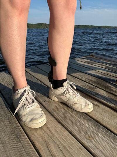 A three-quarter view of a person wearing the strapless step smart brace