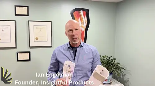 Insightful Products founder, Ian Engelman, comparing the CMT Step-Smart to other braces in his office