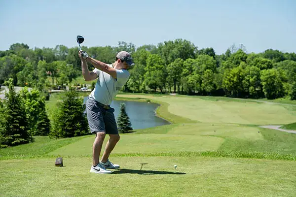 A golfer teeing off on the course